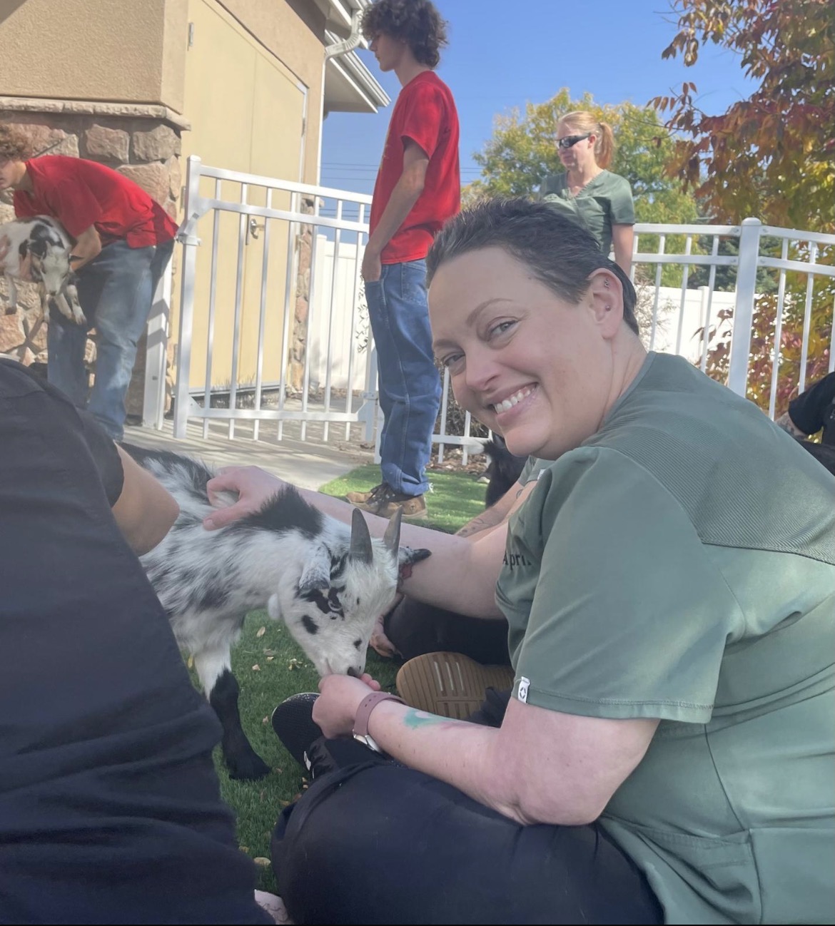 Team member feeding a baby goat