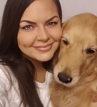 Kamala M. smiling with a dog Kamala M. smiling with a dog