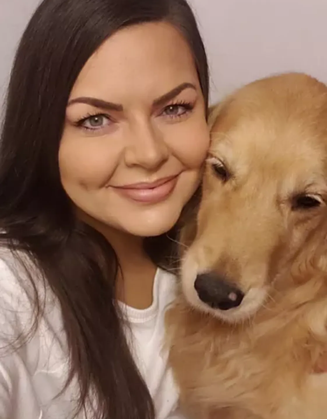 Kamala M. smiling with a dog Kamala M. smiling with a dog