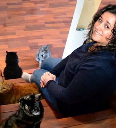 Becky sitting on the stairs with cats Becky sitting on the stairs with cats