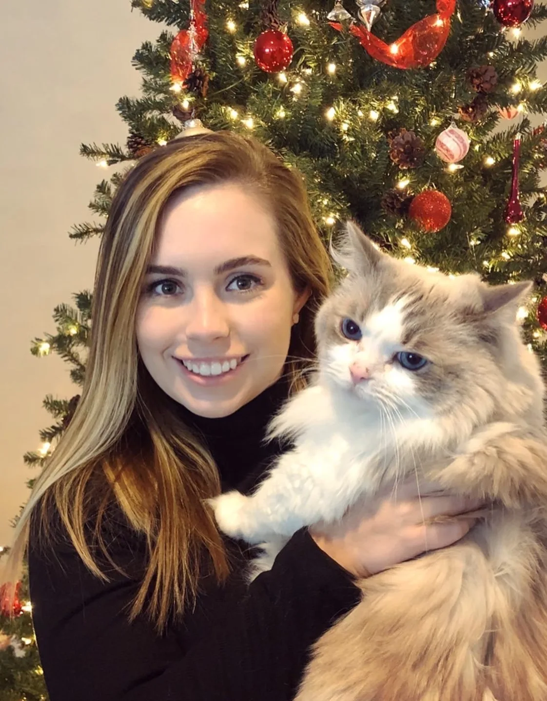 Catherine holding a large long-haired cat. Catherine holding a large long-haired cat.