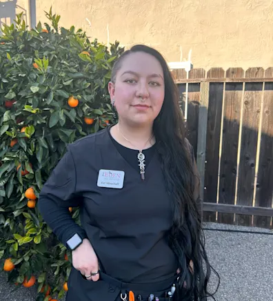 a staff member posing for a photo a staff member posing for a photo