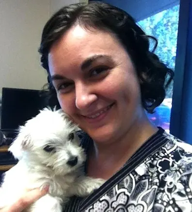 Maggie holding onto a white fluffy puppy. Maggie holding onto a white fluffy puppy.