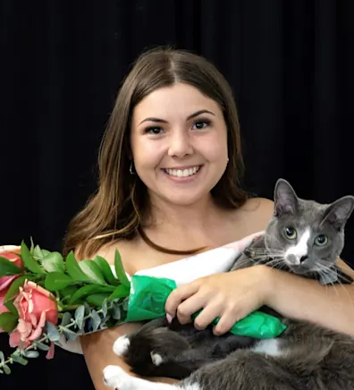 Haylee Weimer holding onto a cat. Haylee Weimer holding onto a cat.