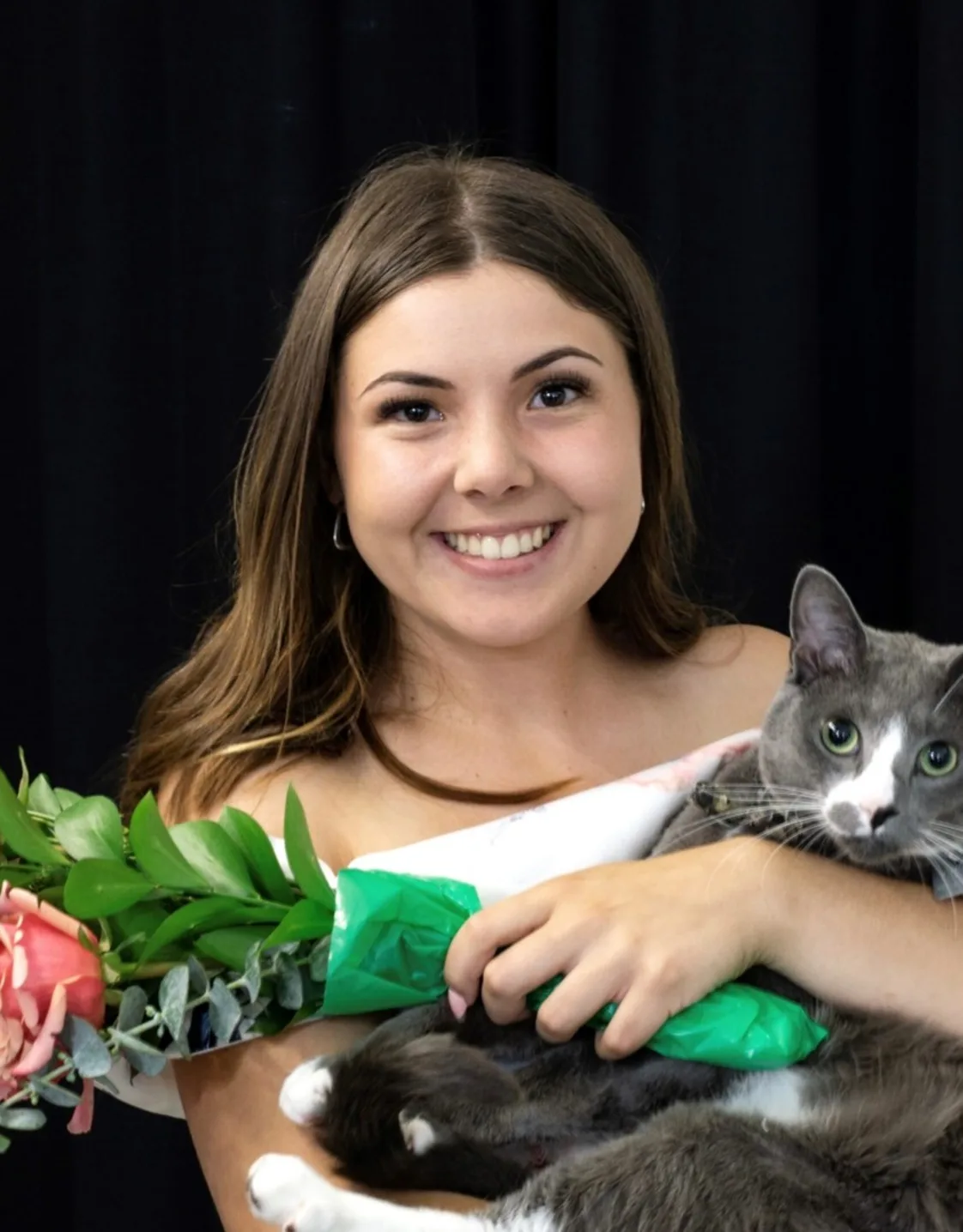 Haylee Weimer holding onto a cat. Haylee Weimer holding onto a cat.
