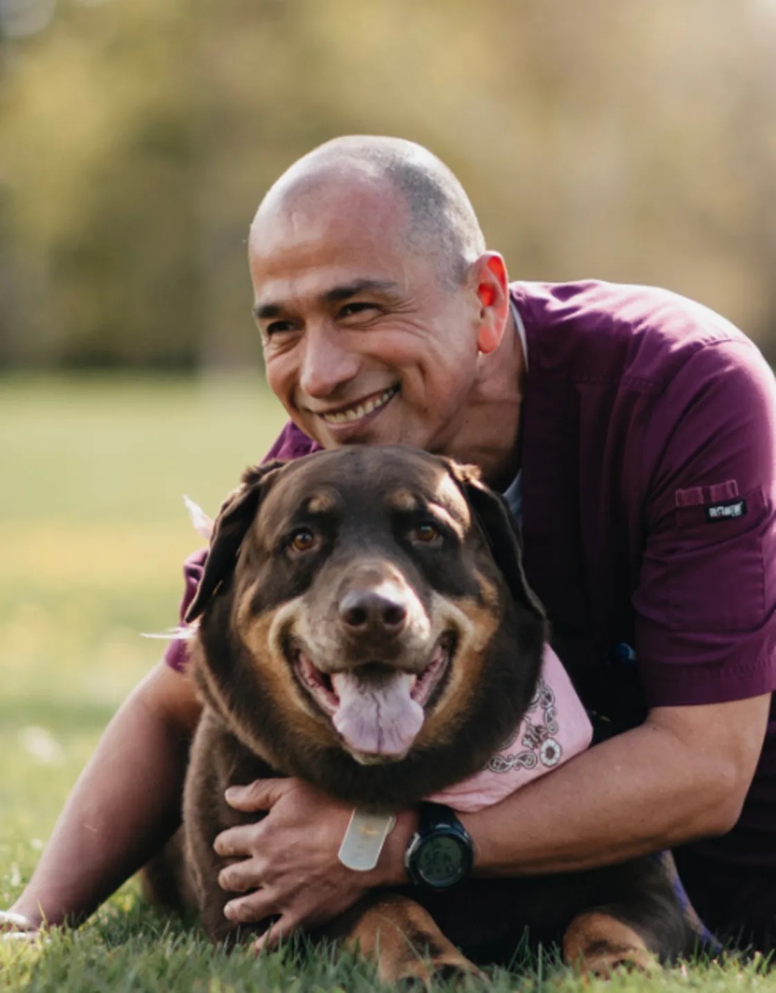 Ramon Lopez laying in grass with a large brown dog Ramon Lopez laying in grass with a large brown dog