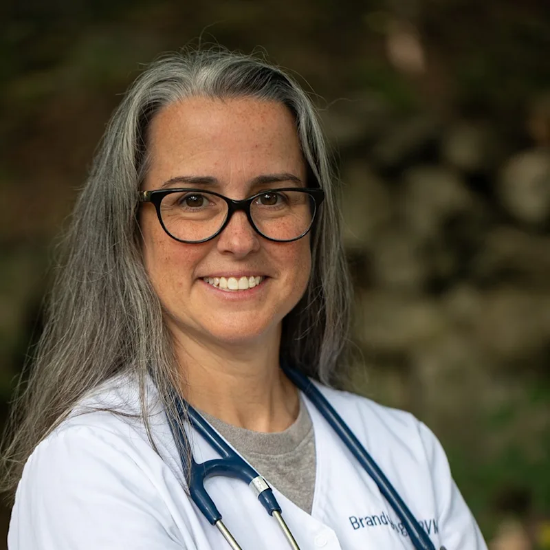 Dr. Brandy Tanguay in front of a tree Dr. Brandy Tanguay in front of a tree