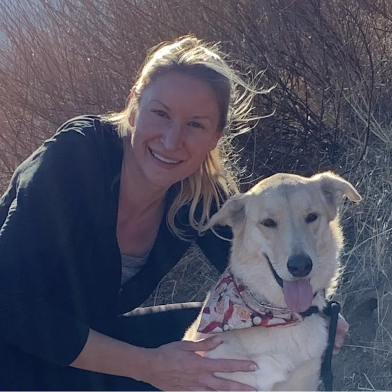 Daina smiling holding a fluffy small dog Daina smiling holding a fluffy small dog
