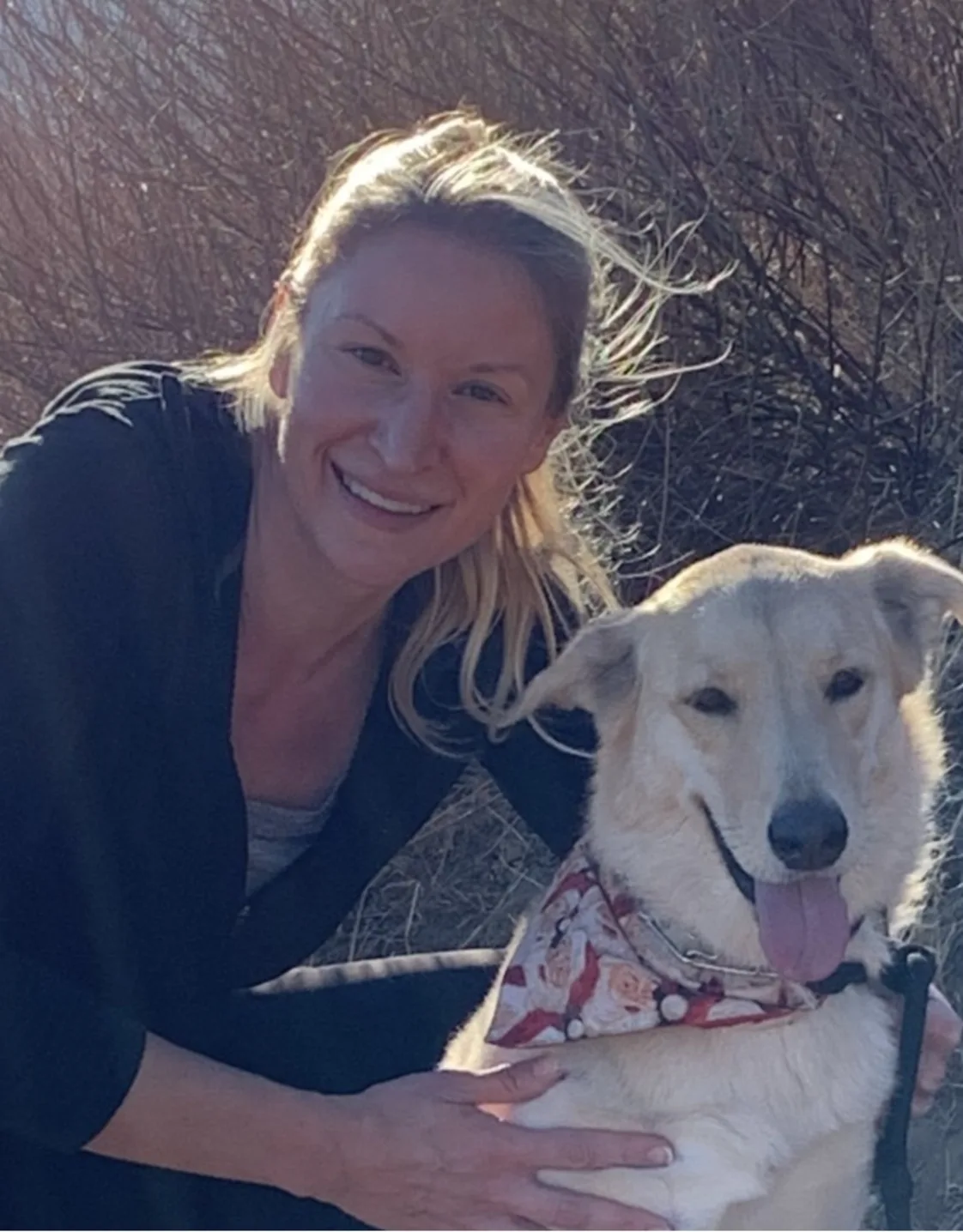 Daina smiling holding a fluffy small dog Daina smiling holding a fluffy small dog