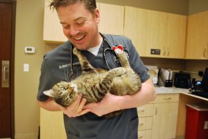 Animal Care Center of Polaris smiling doctor holding cat