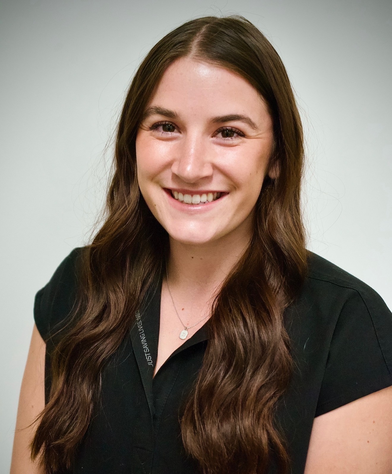 Cecily Momeyer VA wearing a black shirt, smiling in headshot