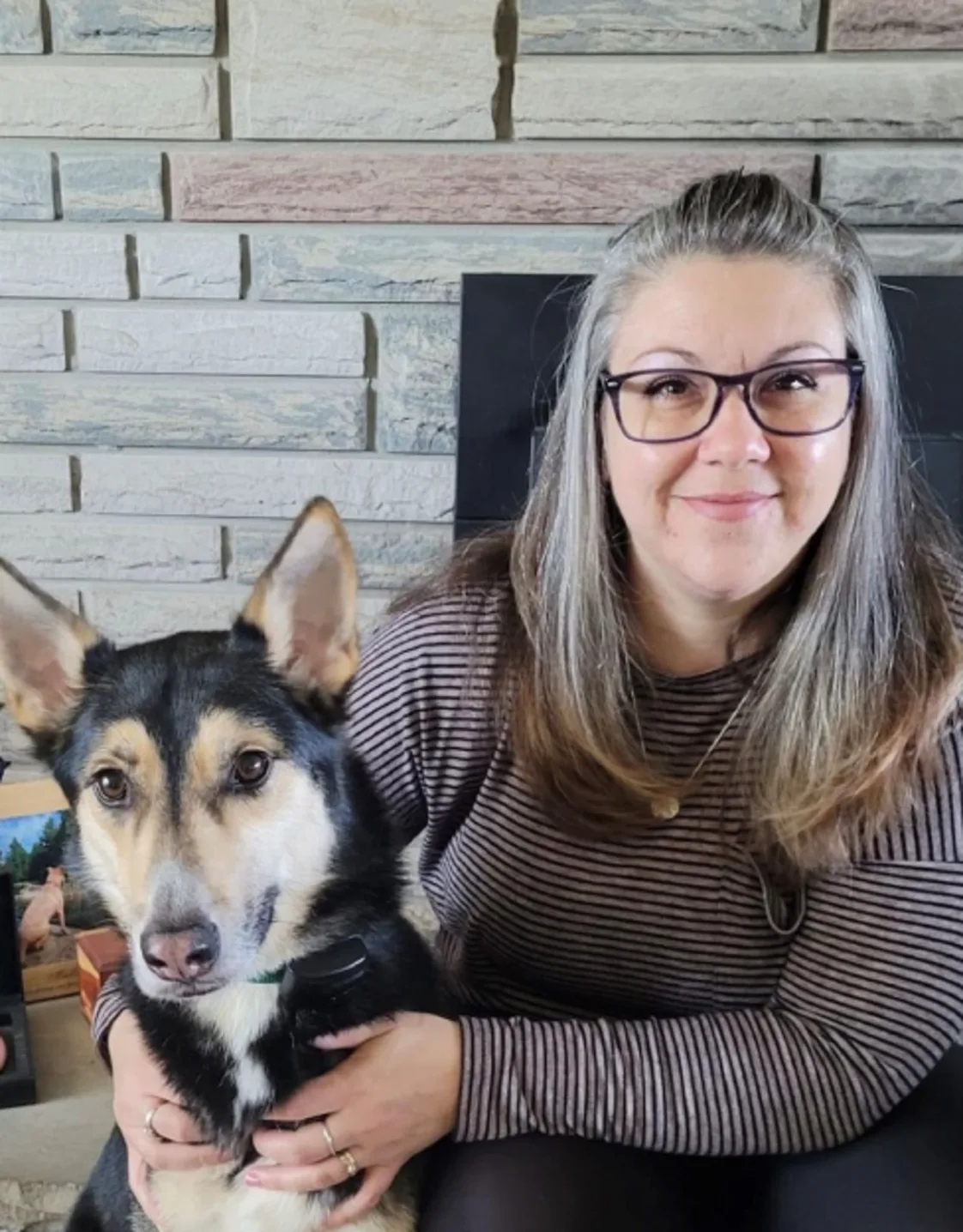 Tanya smiling and hugging two dogs Tanya smiling and hugging two dogs