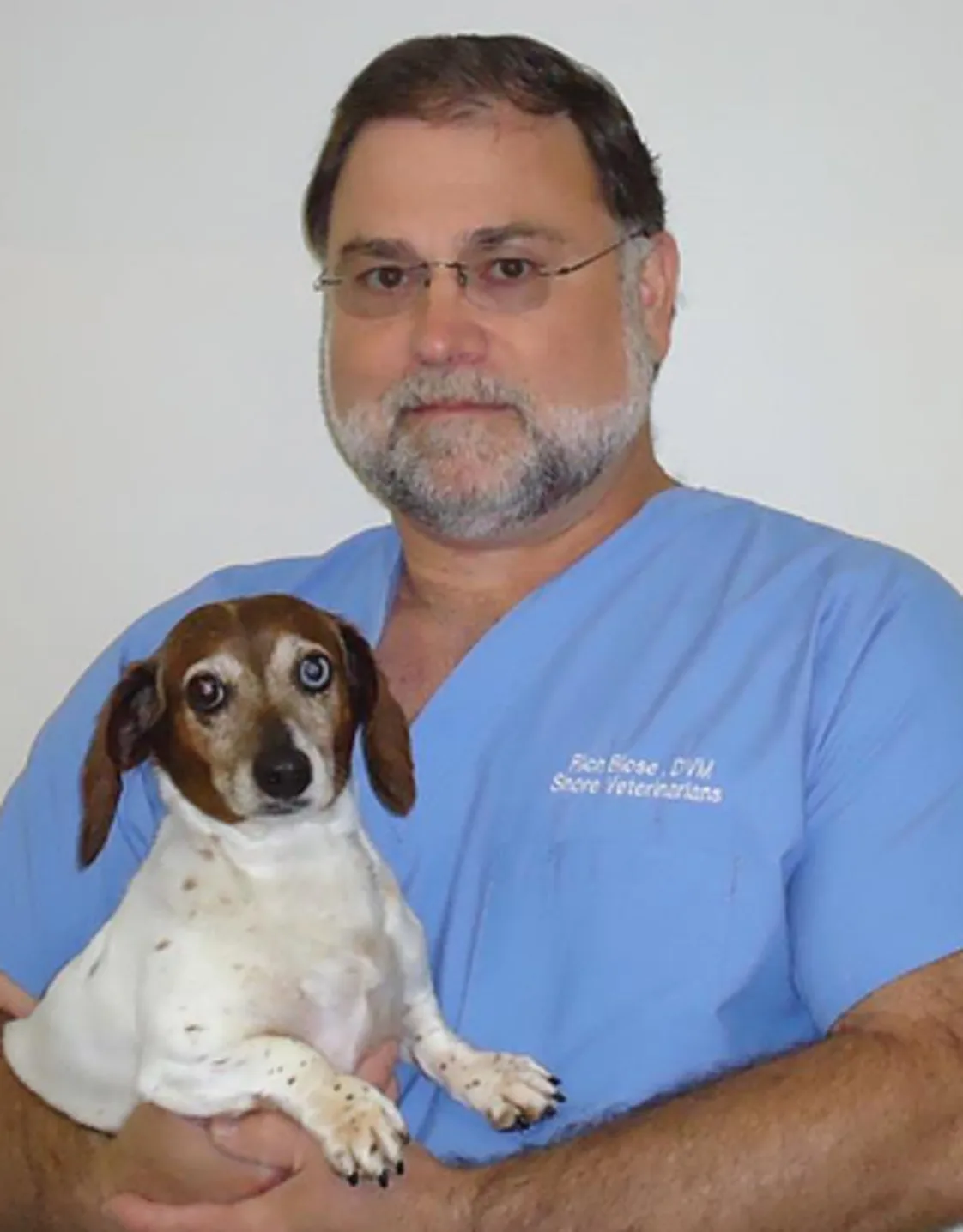 Dr. Blose with a puppy. Dr. Blose with a puppy.