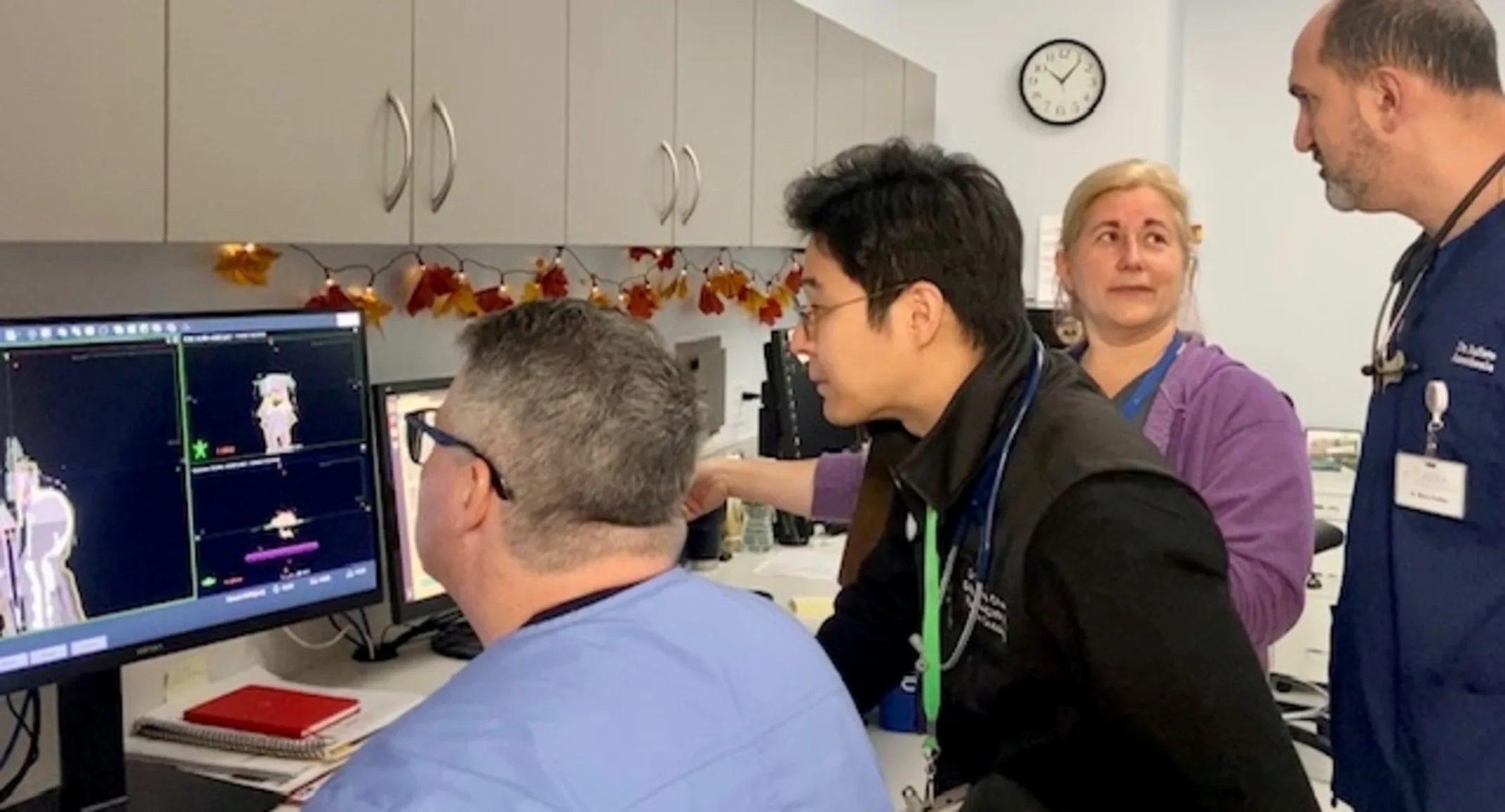 Staff analyzing patient's vitals on a computer Staff analyzing patient's vitals on a computer