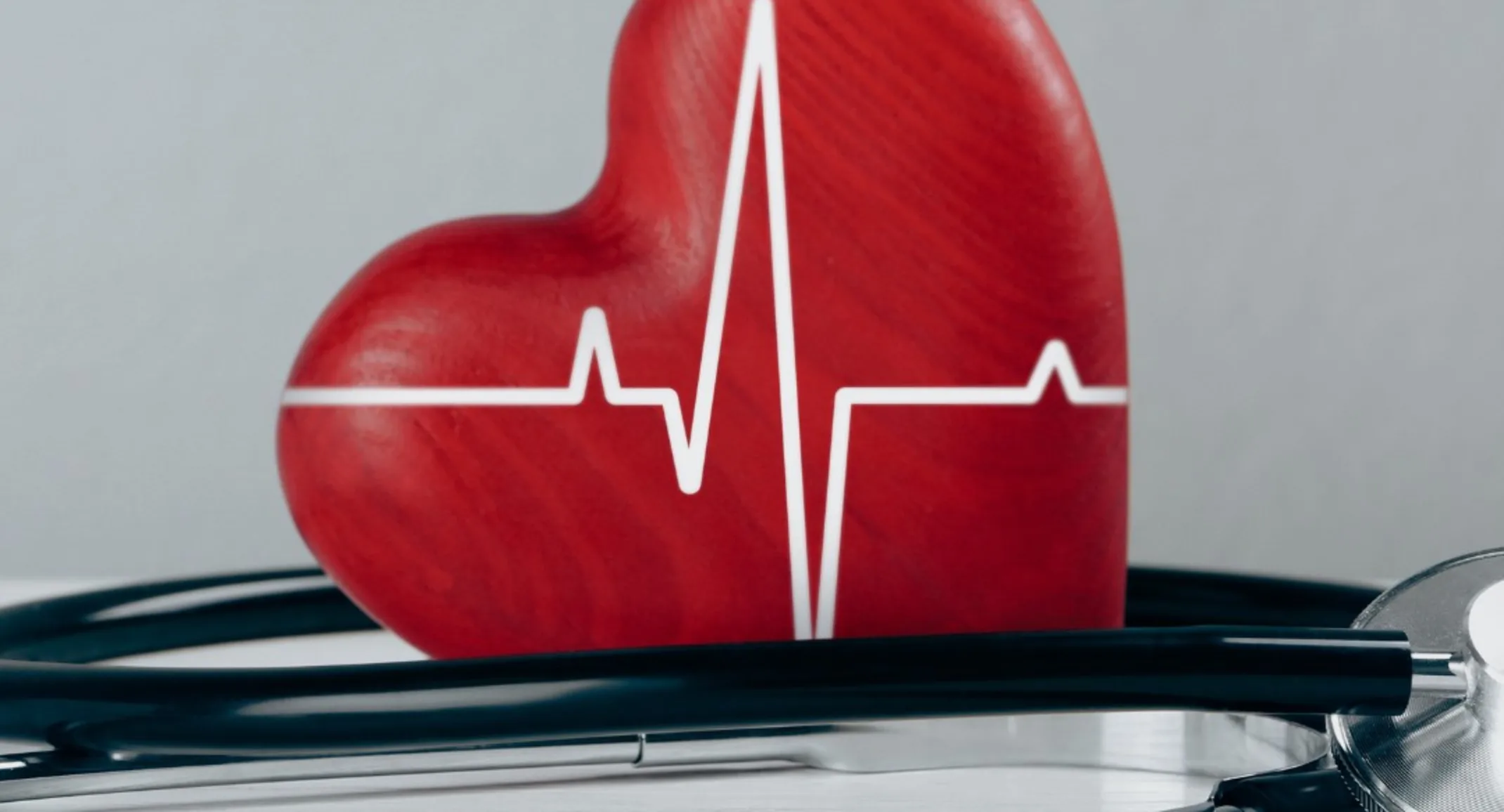 red heart with lifeline printer on it and a stethoscope next to it. red heart with lifeline printer on it and a stethoscope next to it.