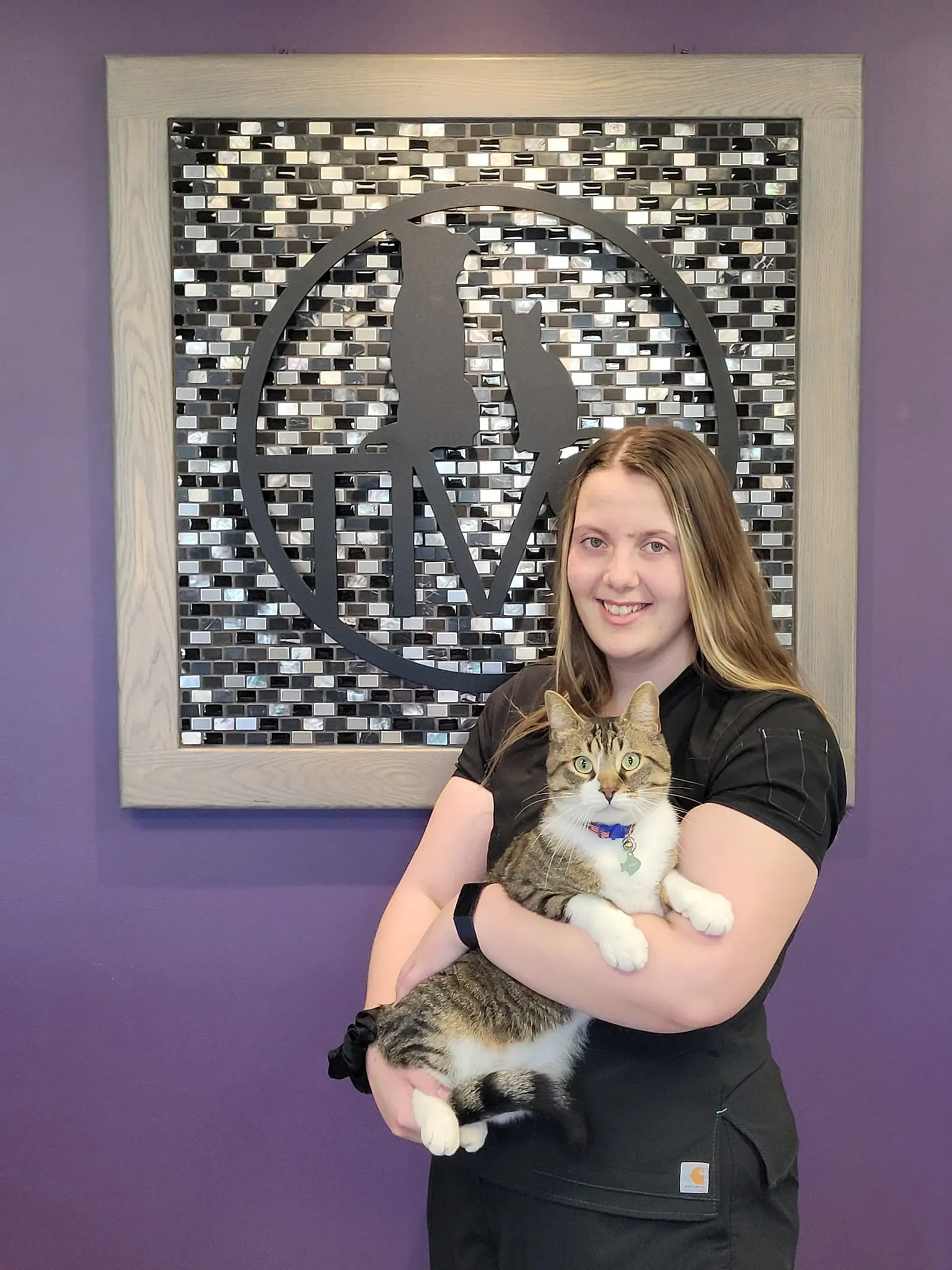 Tessa holding a white and brown cat