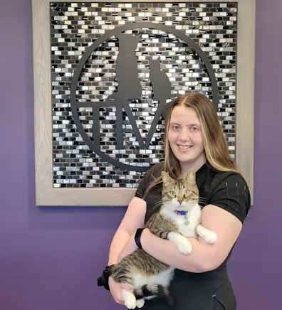 Tessa holding a white and brown cat Tessa holding a white and brown cat