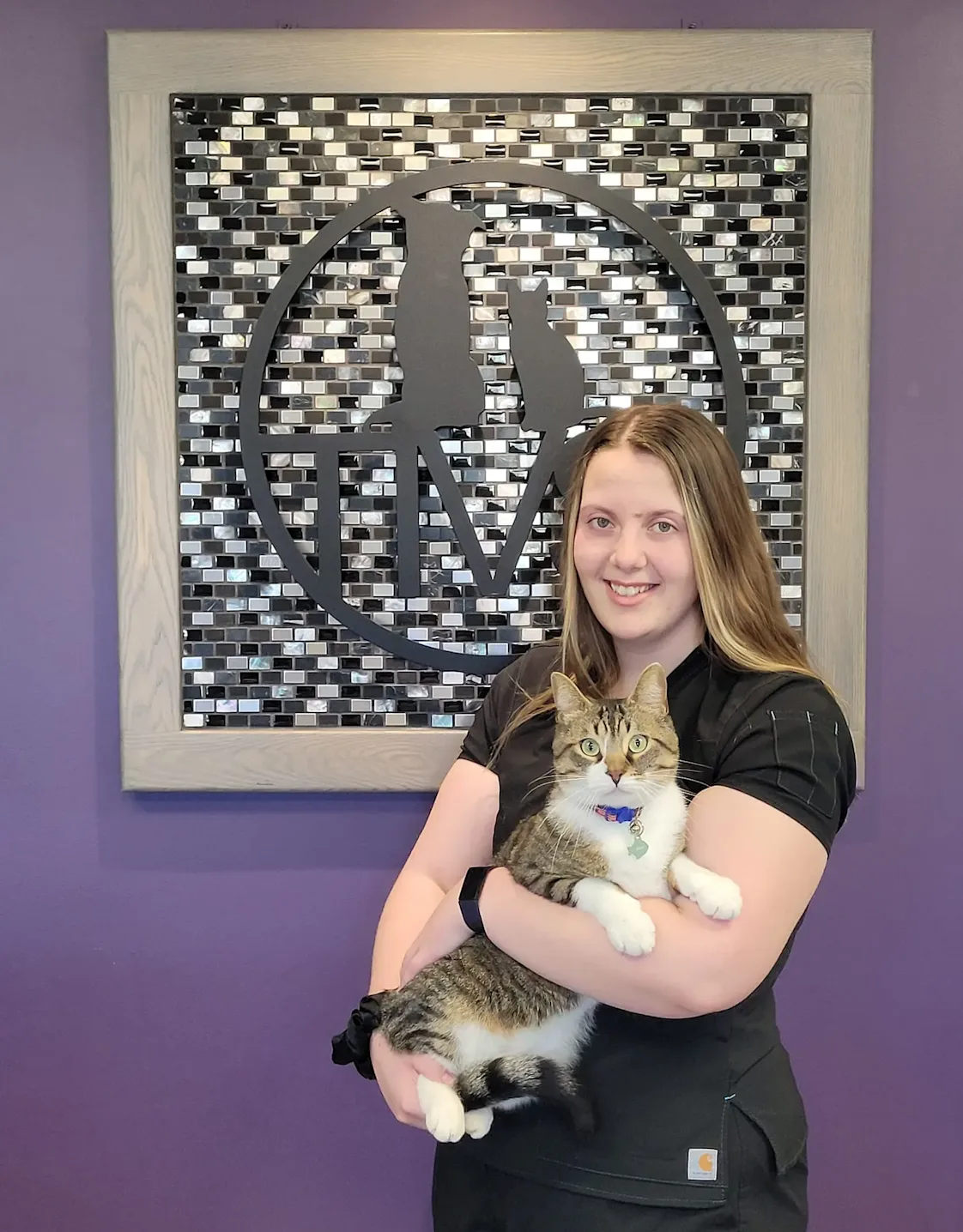 Tessa holding a white and brown cat Tessa holding a white and brown cat