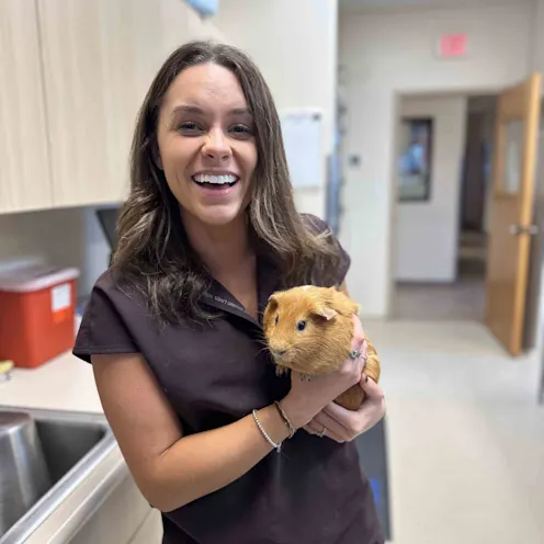 Dr. DeBruhl Holding a Guinea Pig Dr. DeBruhl Holding a Guinea Pig