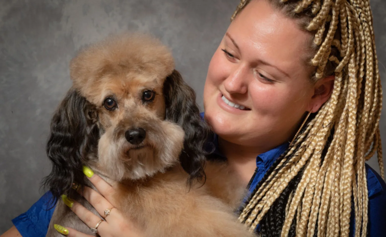 Staff member with a brown dog at The Animalife Veterinary Center Staff member with a brown dog at The Animalife Veterinary Center