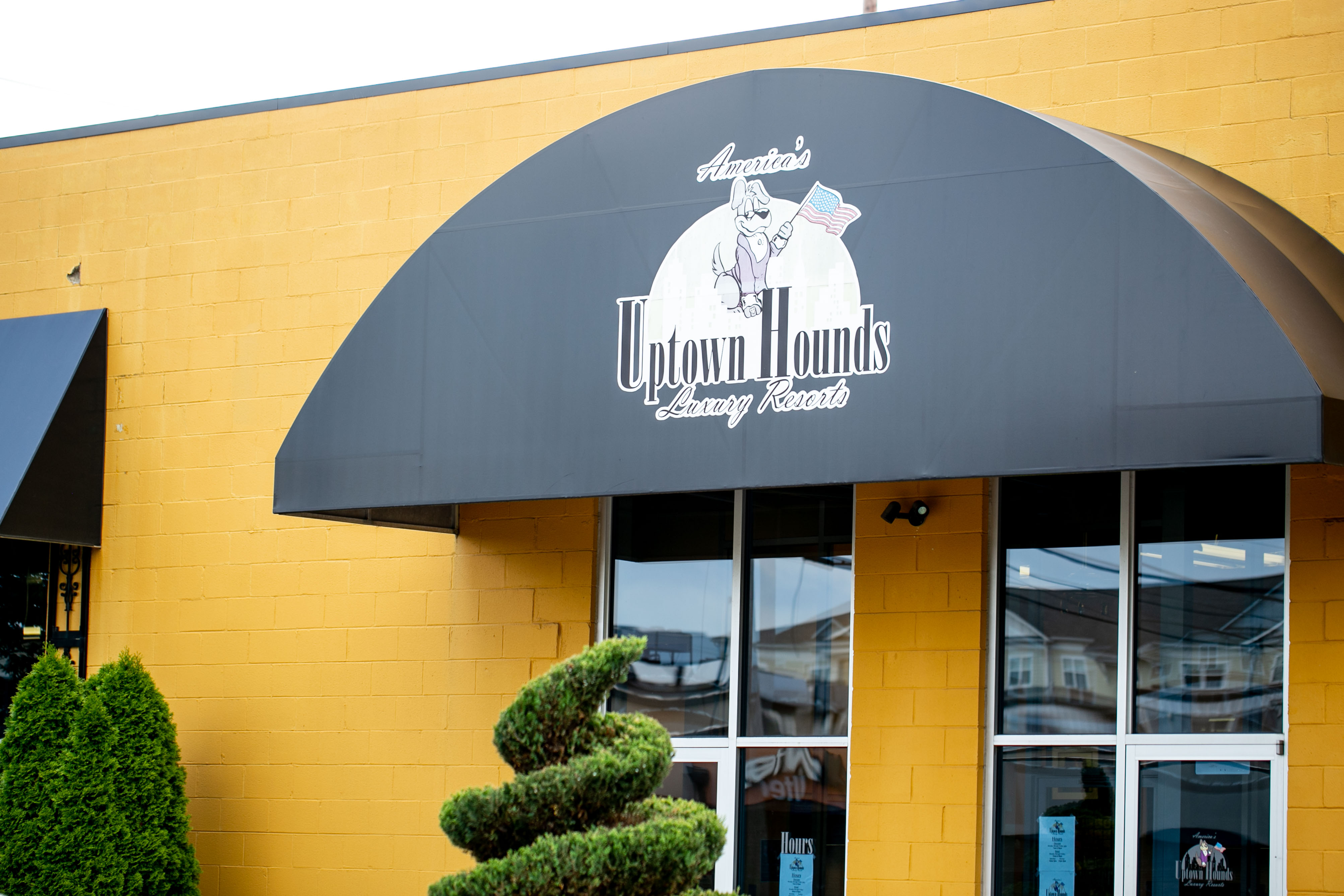 Uptown Hounds Signage on black awning 