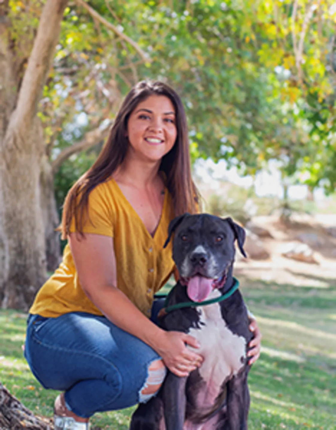 Danielle Martino kneeling with a black and white dog Danielle Martino kneeling with a black and white dog