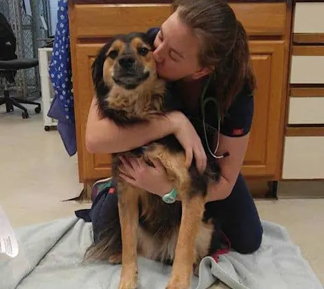 Staff member at Strawbridge Animal Care with a happy puppy Staff member at Strawbridge Animal Care with a happy puppy