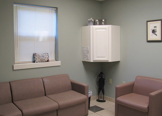 Poquoson Veterinary Hospital Consultation Room. There's a sofa and love seat for customers to sit in the room. 