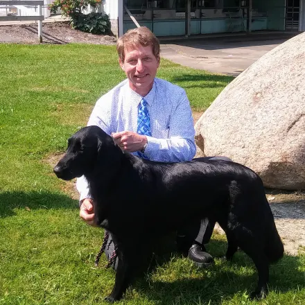 Dr. Randy S. Sliker with black dog