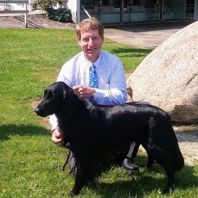 Dr. Randy S. Sliker with black dog Dr. Randy S. Sliker with black dog