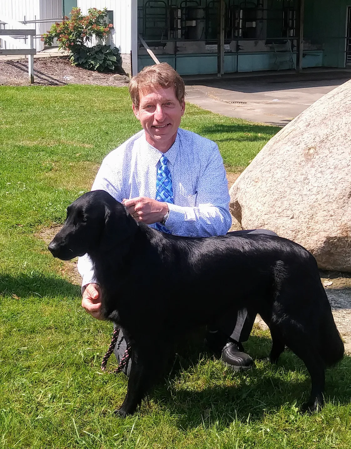 Dr. Randy S. Sliker with black dog Dr. Randy S. Sliker with black dog
