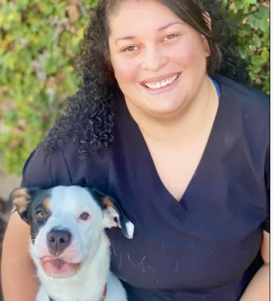 Errika, veterinary technician, sitting with dog