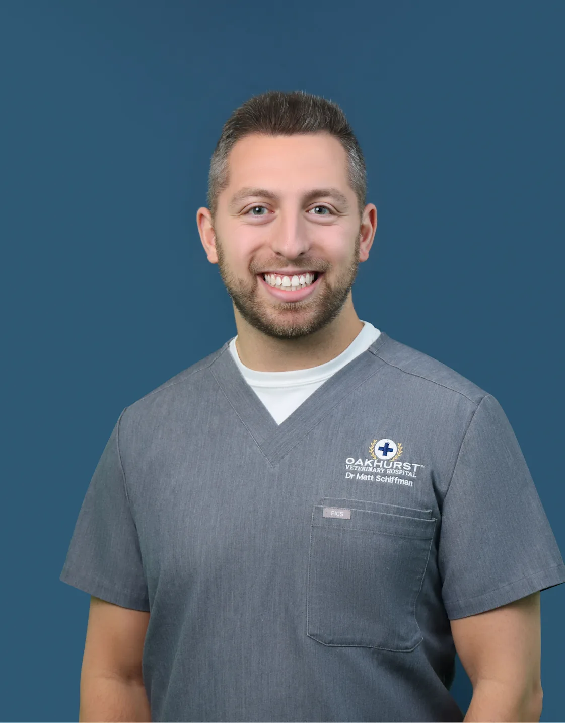Dr. Matthew Schiffman sitting in grass with a dog Dr. Matthew Schiffman sitting in grass with a dog