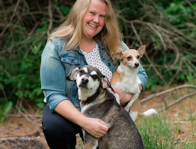 Dr. Alexis Bergstrom smiling at the camera while holding a cat