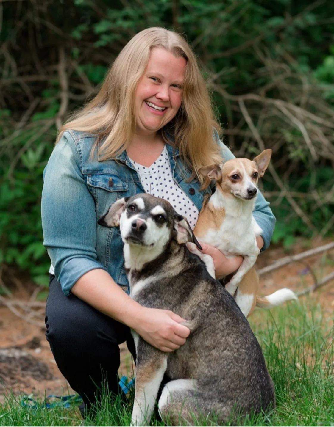 Dr. Alexis Bergstrom smiling at the camera while holding a cat Dr. Alexis Bergstrom smiling at the camera while holding a cat
