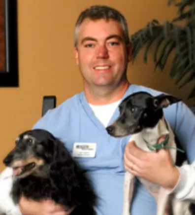 Jim Heine holding two dogs