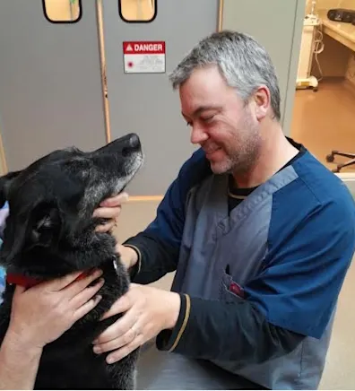 Jim Heine holding two dogs Jim Heine holding two dogs