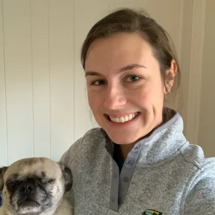 Dr. Melinda Atherton's staff photo from Media Veterinary Hospital where she is taking a selfie photo of herself with her pug dog.