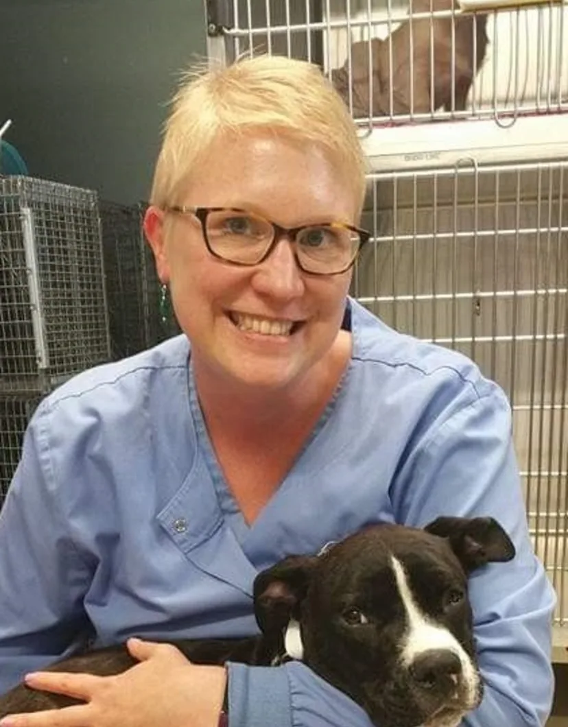 Dr. Sarah Hodges from Midland Animal Clinic with a black and white dog