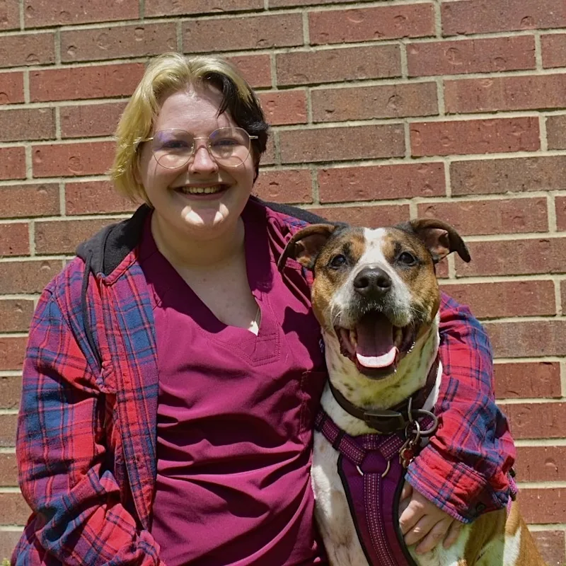 Zee with an arm around a dog Zee with an arm around a dog