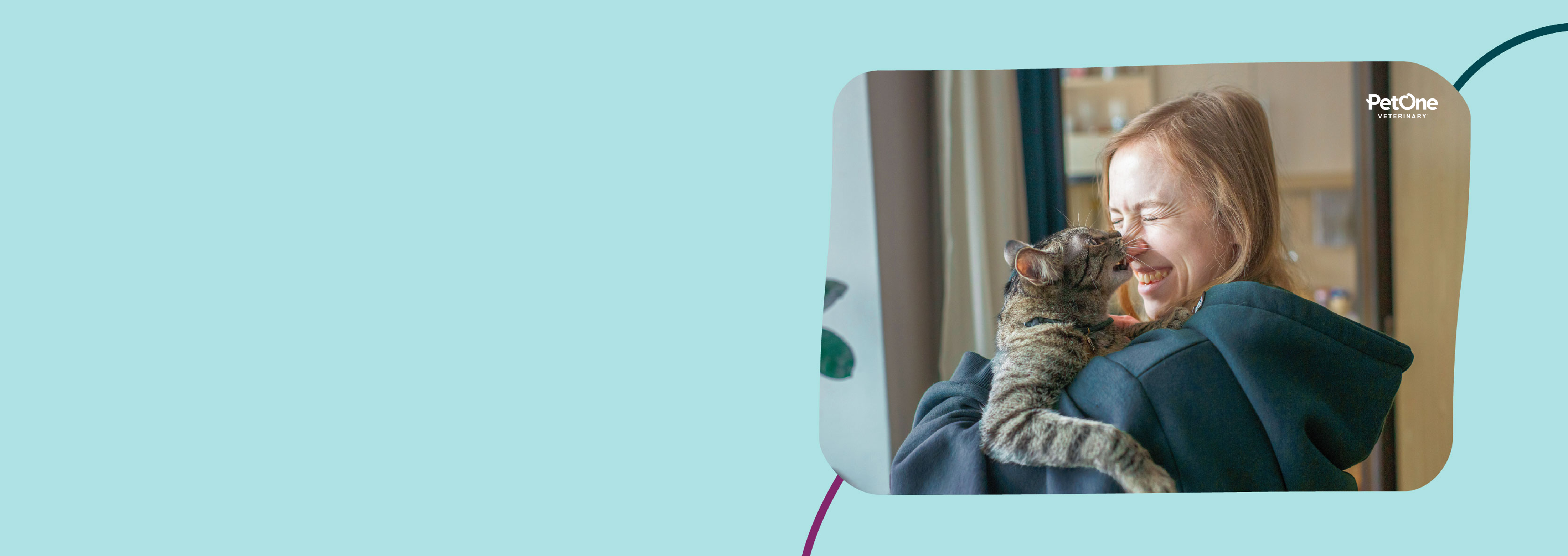 A woman holding a cat in her arms while the cat reaches up and licks the woman's nose.