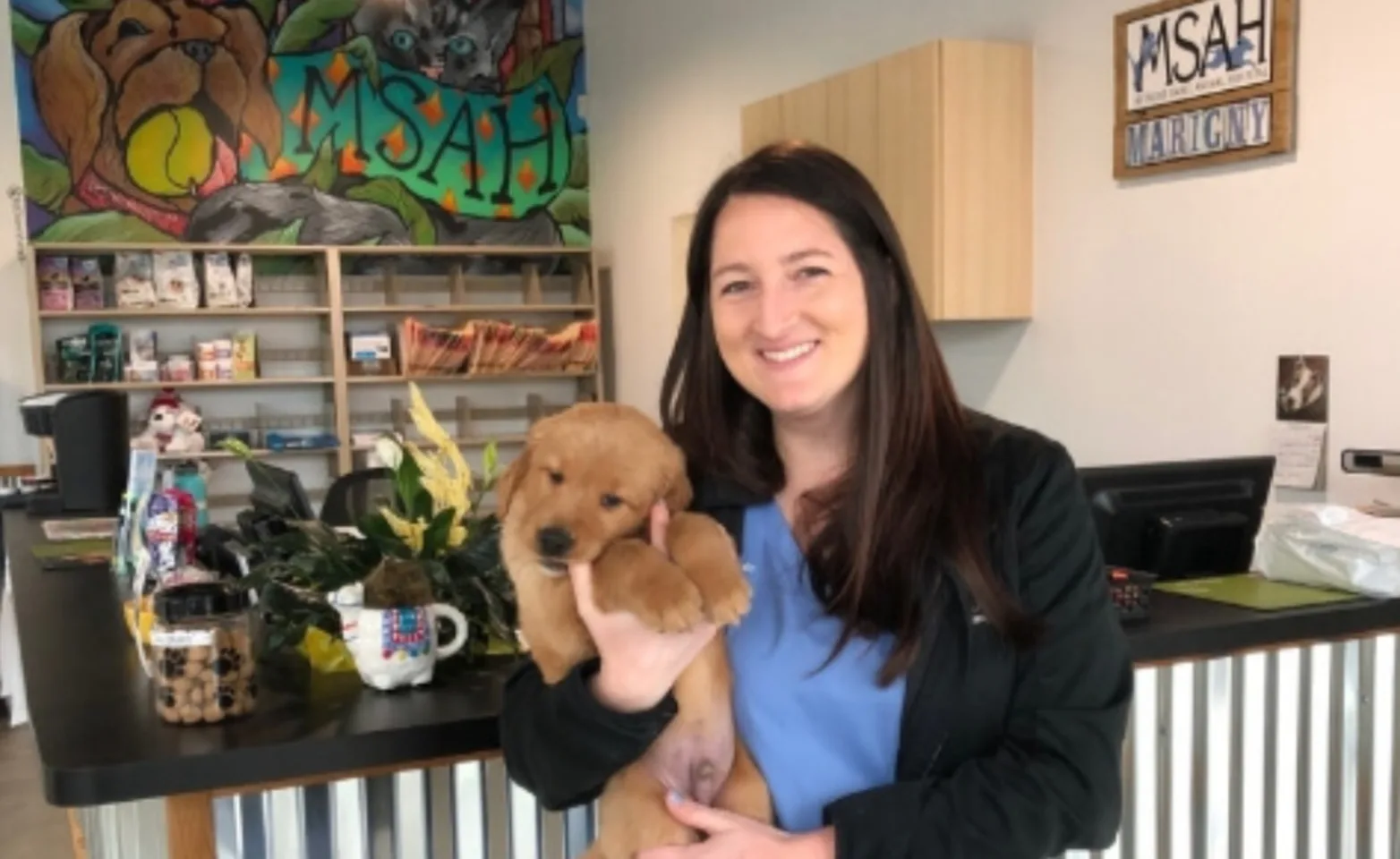 Marigny Clinic Interior with Staff Member Holding a Puppy