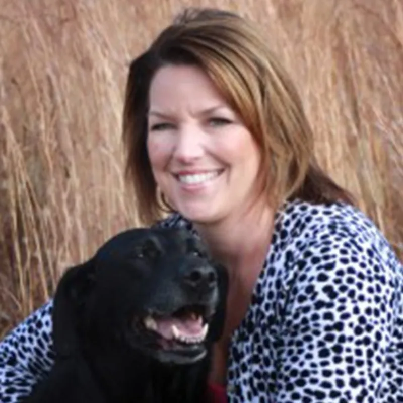 Dr. Leslie Burchett with A dog Dr. Leslie Burchett with A dog