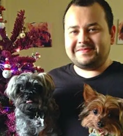 Brandon holding two small dogs