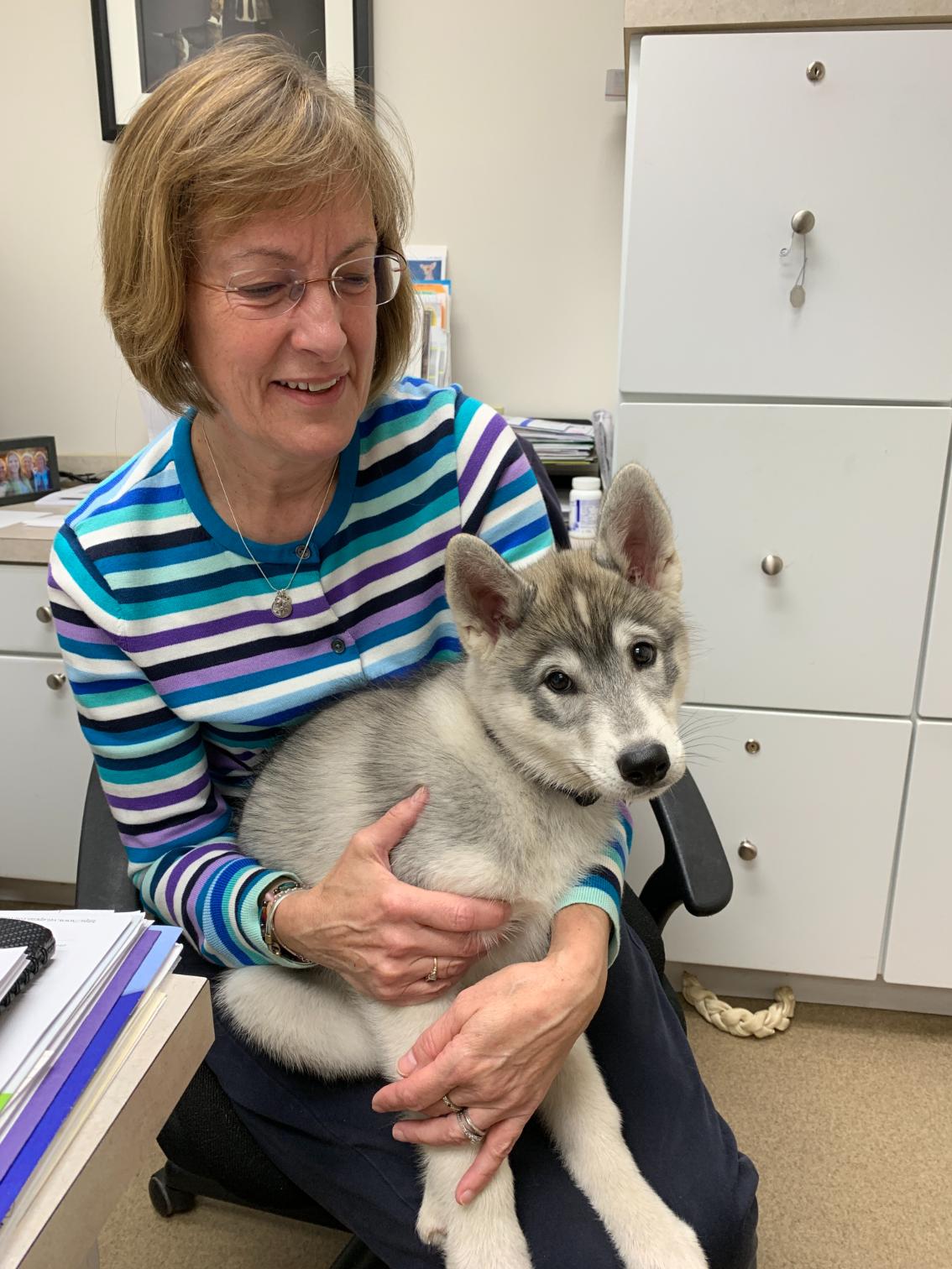 Sharon holding a small white dog