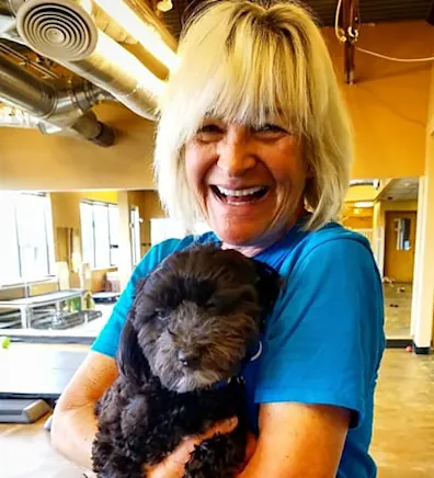 Suzi holding a puppy at Tiny Town small dog daycare in Boulder, CO Suzi holding a puppy at Tiny Town small dog daycare in Boulder, CO