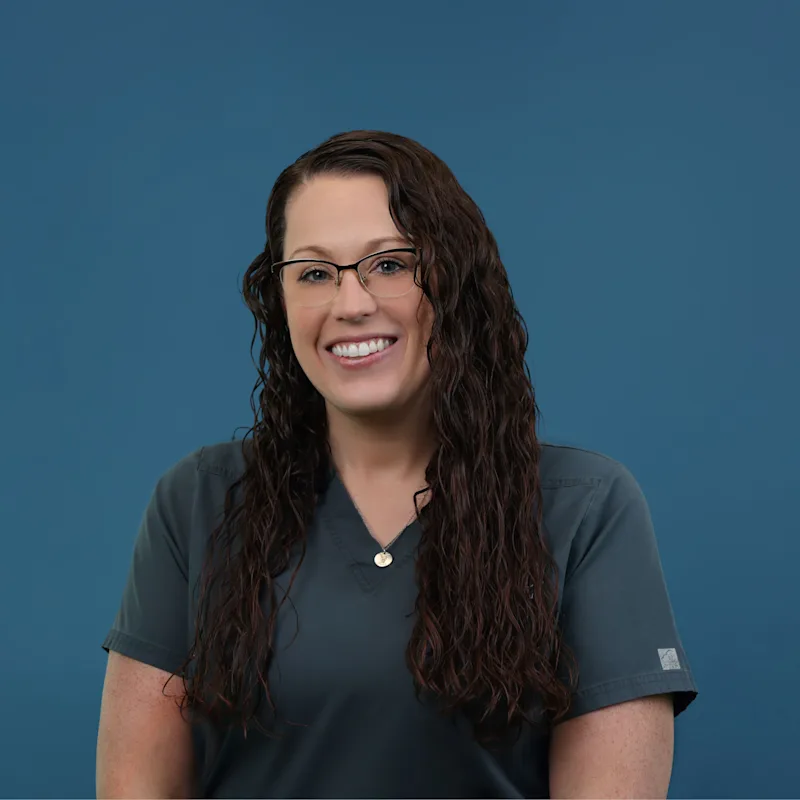 Dr. Melissa Riggio posing with a dog Dr. Melissa Riggio posing with a dog