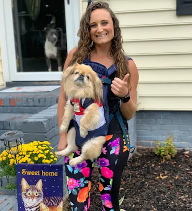 Heather Lewis with a dog strapped on her. Heather Lewis with a dog strapped on her.