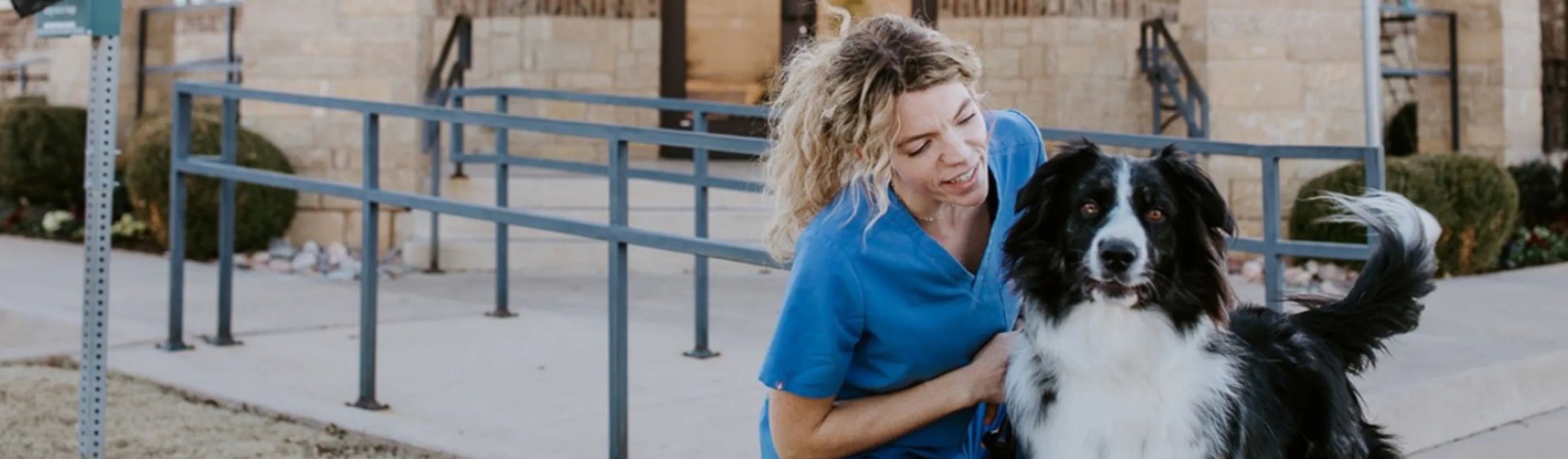 Veterinarian with Dog in Front of Clinic Building Veterinarian with Dog in Front of Clinic Building