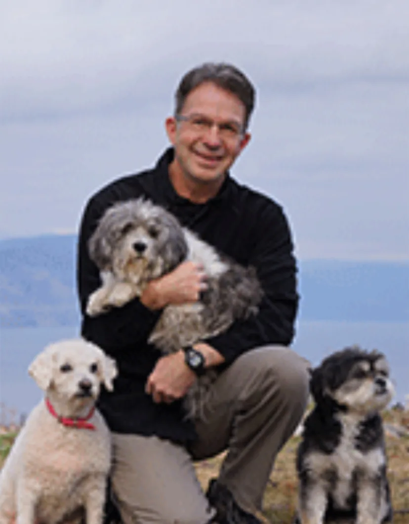 Dr. Kopp with three dogs outside